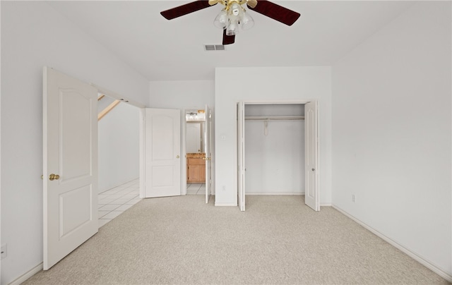 unfurnished bedroom featuring light carpet, ceiling fan, and ensuite bathroom