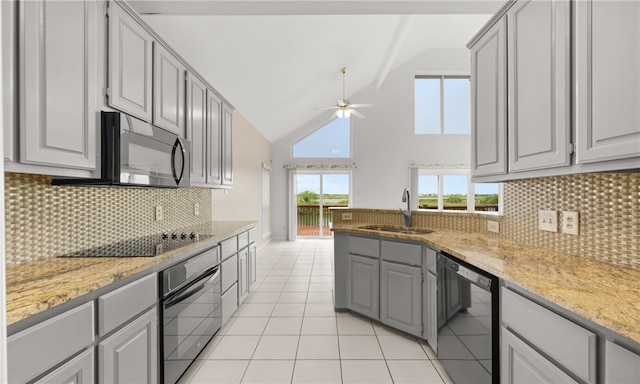 kitchen featuring black appliances, gray cabinetry, backsplash, and sink