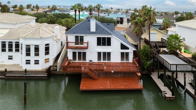 back of house with a deck with water view