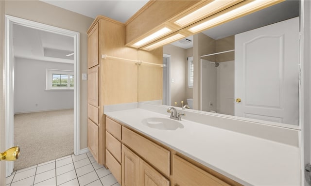 bathroom featuring toilet, vanity, and tile patterned floors