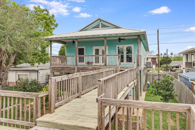 3401 Laguna Shores Rd, Corpus Christi, TX 78418 - view of front facade featuring stairs, a ceiling fan, fence, and a wooden deck