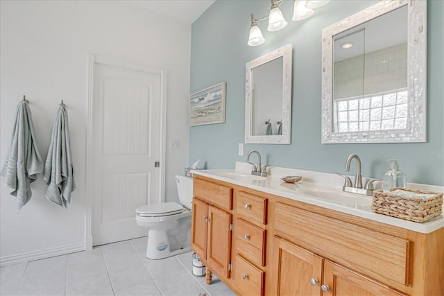 bathroom with toilet, double vanity, tile patterned floors, and a sink
