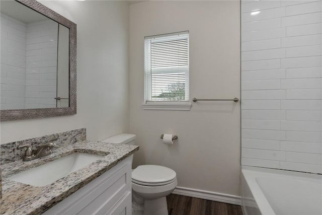 bathroom featuring vanity, toilet, and hardwood / wood-style floors