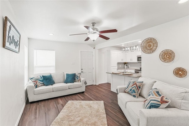 living area with a ceiling fan, baseboards, dark wood-style flooring, and recessed lighting