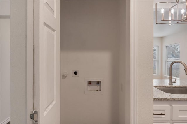 laundry room with hookup for a washing machine, a sink, electric dryer hookup, a chandelier, and laundry area