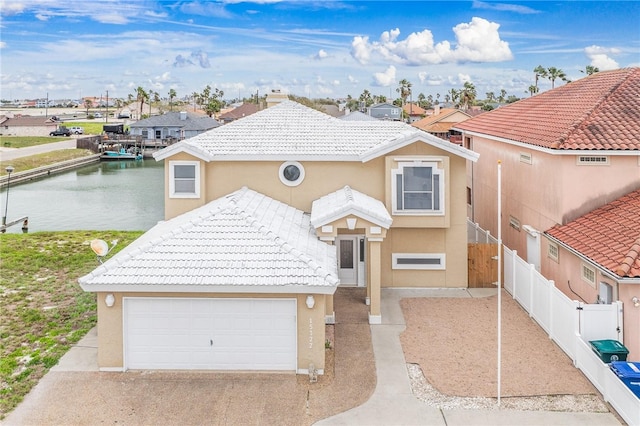 view of front of property featuring a garage and a water view