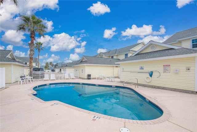 pool featuring a patio area and fence