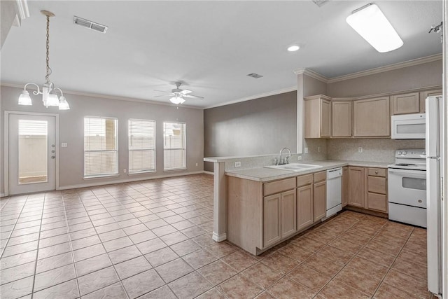 kitchen featuring visible vents, open floor plan, light countertops, white appliances, and a sink