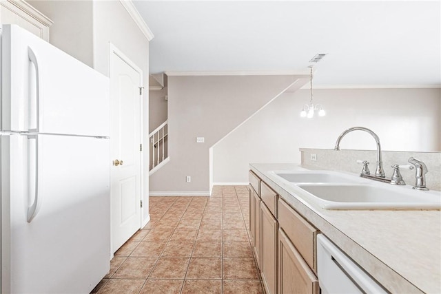 kitchen featuring visible vents, a sink, white appliances, light tile patterned flooring, and crown molding