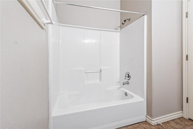 bathroom with tile patterned flooring, baseboards, and  shower combination