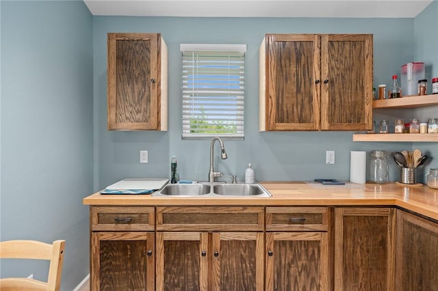 kitchen with brown cabinets, light countertops, and a sink