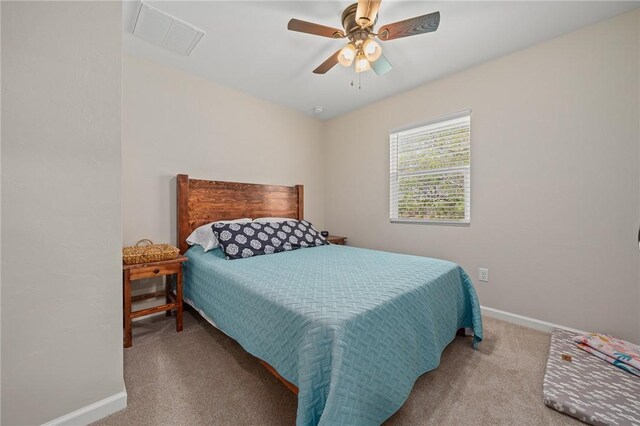 bedroom with visible vents, baseboards, a ceiling fan, and carpet