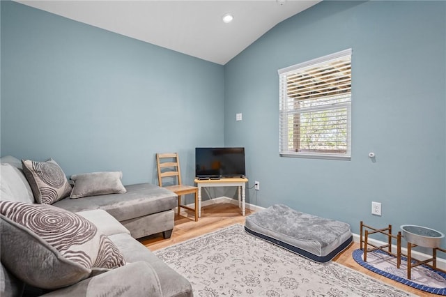 living room featuring recessed lighting, baseboards, vaulted ceiling, and wood finished floors