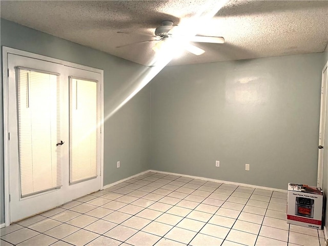 bonus room with heating unit, ceiling fan, light tile patterned floors, and a textured ceiling