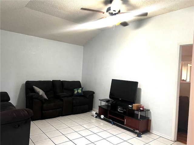 living room featuring a textured ceiling, ceiling fan, light tile patterned floors, and lofted ceiling