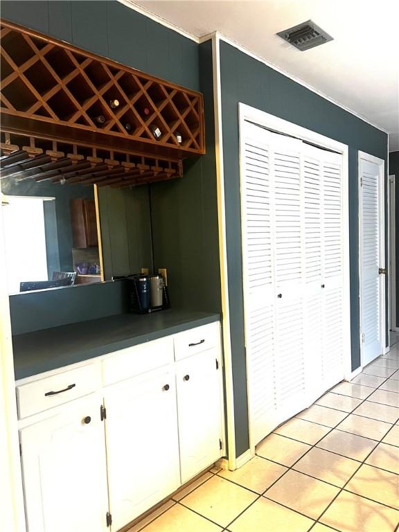 kitchen with white cabinets and light tile patterned floors