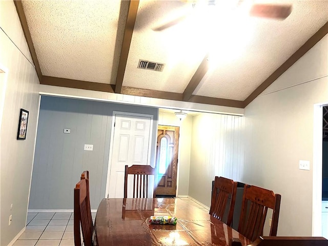 tiled dining area with vaulted ceiling with beams, wood walls, and ceiling fan