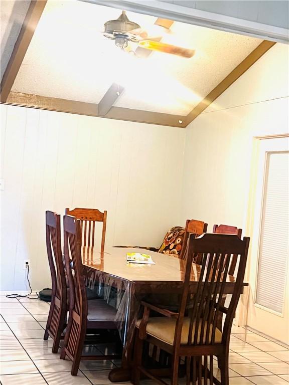 tiled dining area featuring ceiling fan