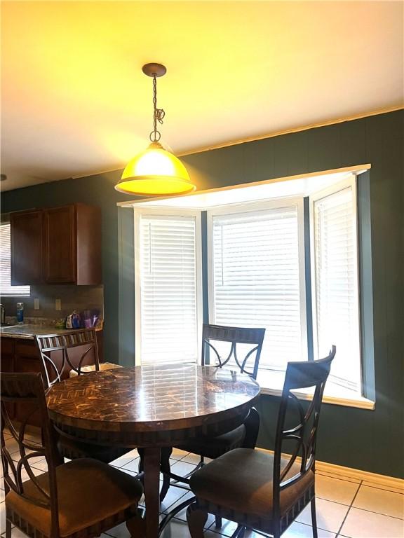 tiled dining area with a wealth of natural light