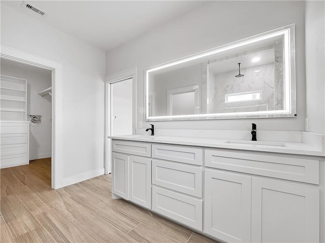 6222 Sadie St, Corpus Christi, TX 78415 - bathroom featuring visible vents, a shower, wood finish floors, and a sink