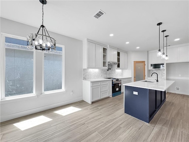 6222 Sadie St, Corpus Christi, TX 78415 - kitchen featuring a sink, stainless steel appliances, a notable chandelier, and white cabinets