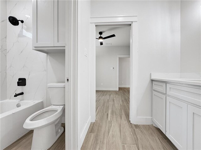 6222 Sadie St, Corpus Christi, TX 78415 - full bathroom with wood finish floors, toilet, shower / washtub combination, baseboards, and vanity