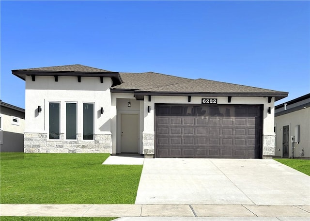 6222 Sadie St, Corpus Christi, TX 78415 - prairie-style house with stucco siding, driveway, stone siding, a front yard, and a garage