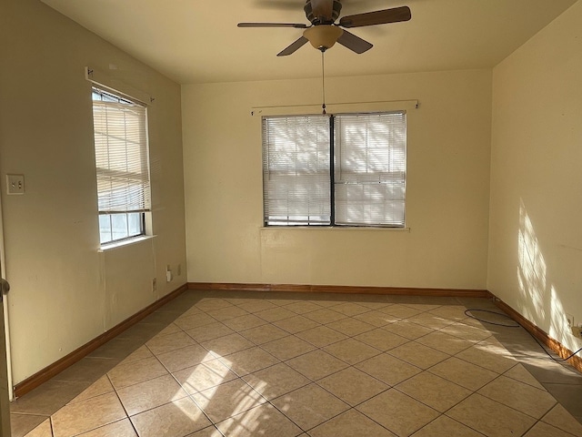 tiled empty room with ceiling fan