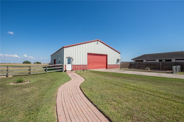 view of outdoor structure with a garage and a lawn