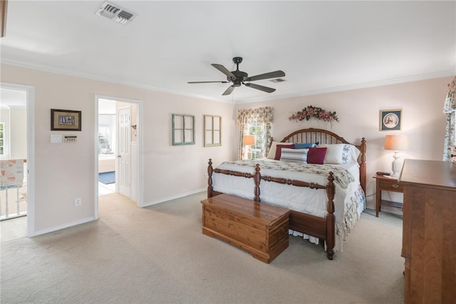 bedroom featuring ceiling fan, crown molding, and light carpet