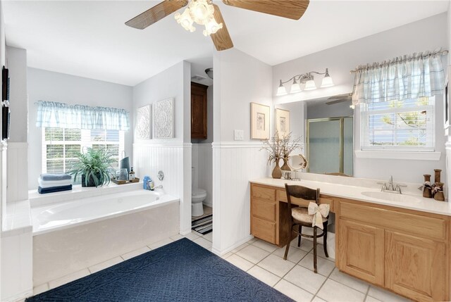 full bathroom featuring vanity, tile patterned flooring, ceiling fan, separate shower and tub, and toilet