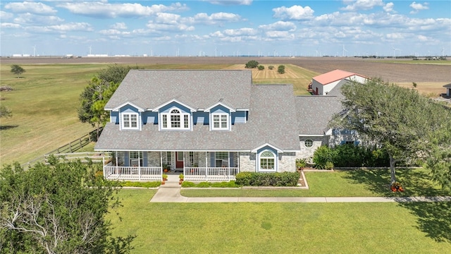 cape cod house featuring a porch and a rural view