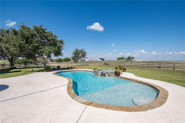 view of swimming pool featuring a lawn, an in ground hot tub, a rural view, and a patio