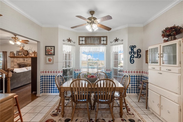 dining room featuring crown molding, light tile patterned flooring, and ceiling fan