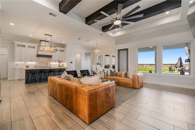 734 Buffalo Creek Dr, Corpus Christi, TX 78415 - living area with a chandelier, a ceiling fan, recessed lighting, ornamental molding, and beamed ceiling