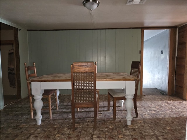 dining space with wood walls