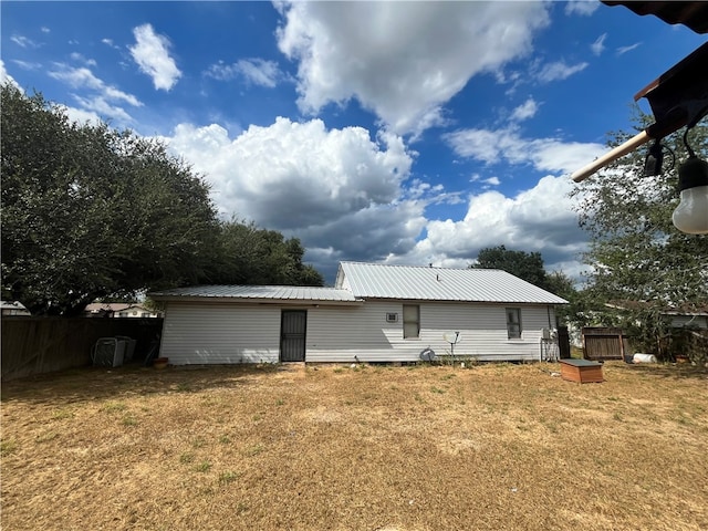 rear view of property featuring a yard