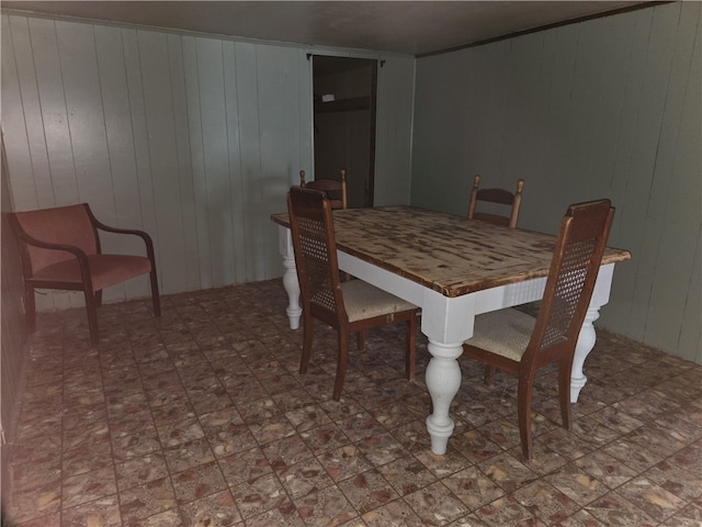 dining room with wood walls