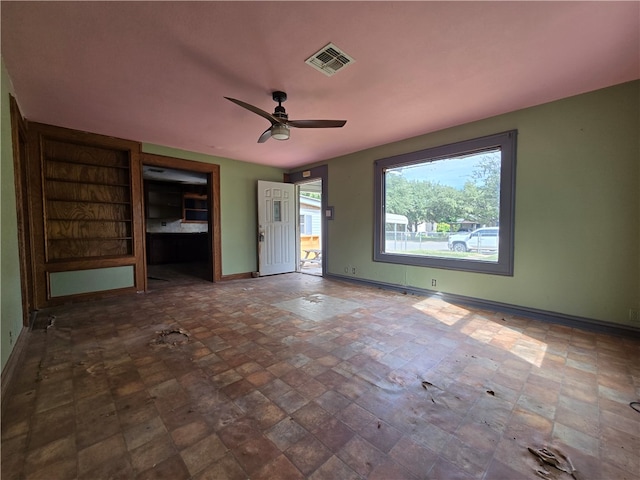 unfurnished living room featuring ceiling fan