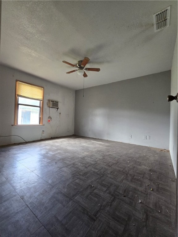 unfurnished room featuring ceiling fan, a textured ceiling, and a wall mounted AC