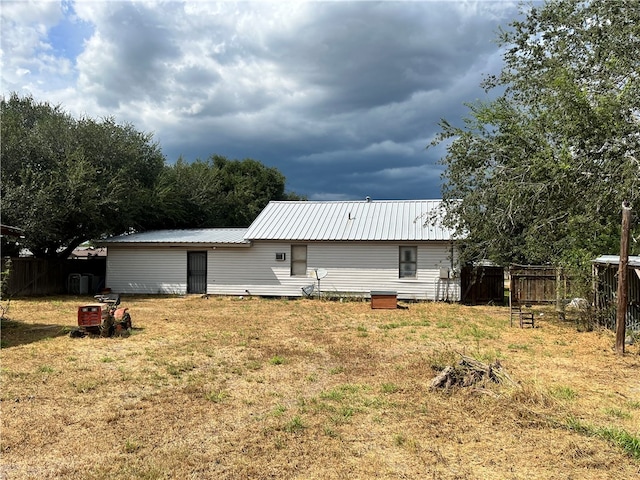 back of property featuring a yard