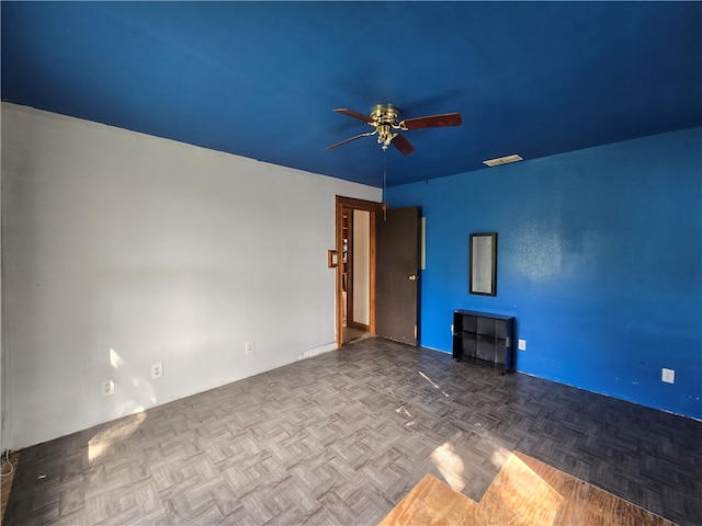 unfurnished living room featuring parquet flooring and ceiling fan