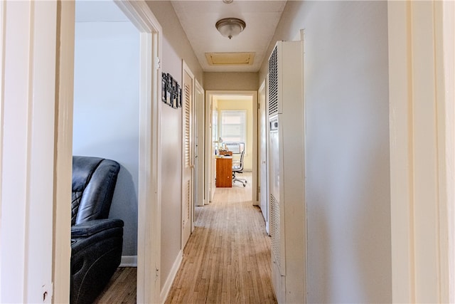 corridor with light hardwood / wood-style flooring