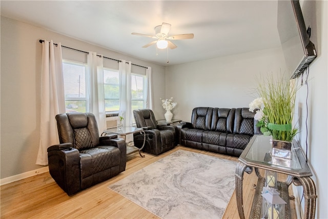 living room with wood-type flooring and ceiling fan