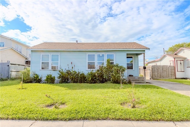 bungalow-style house featuring a front lawn