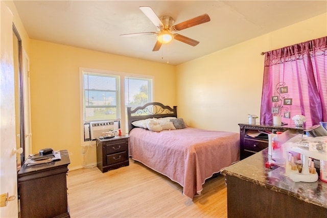 bedroom with light hardwood / wood-style flooring and ceiling fan