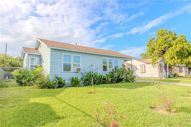 view of front of property with a front lawn and cooling unit