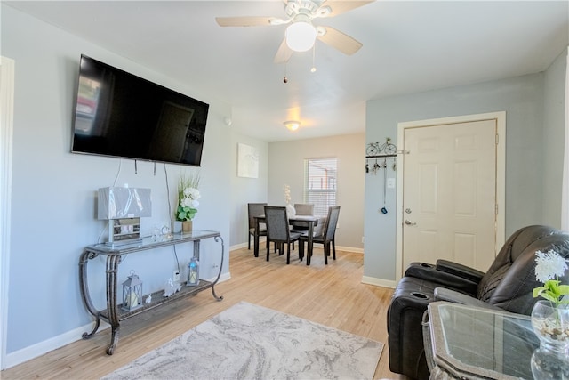 living room featuring light wood-type flooring and ceiling fan