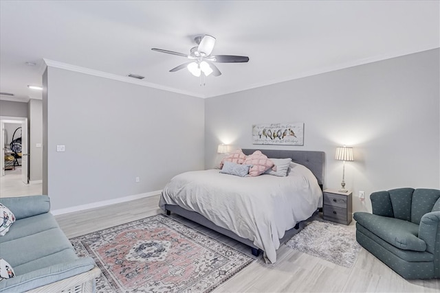 bedroom with hardwood / wood-style floors, ceiling fan, and crown molding