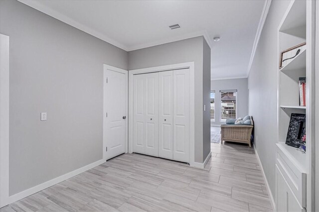 hall featuring light hardwood / wood-style flooring and built in features